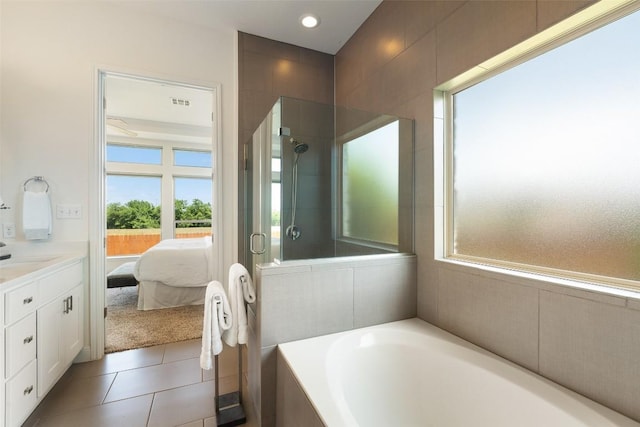 20213 Hidden Gully Ln, Pflugerville, TX 78660 - bathroom with a garden tub, vanity, a shower stall, ensuite bath, and tile patterned flooring