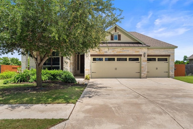 20213 Hidden Gully Ln, Pflugerville, TX 78660 - view of front of house with stone siding, an attached garage, concrete driveway, and a standing seam roof