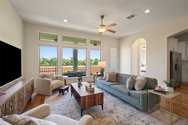 20213 Hidden Gully Ln, Pflugerville, TX 78660 - living area featuring light wood-style flooring, ceiling fan, recessed lighting, and arched walkways