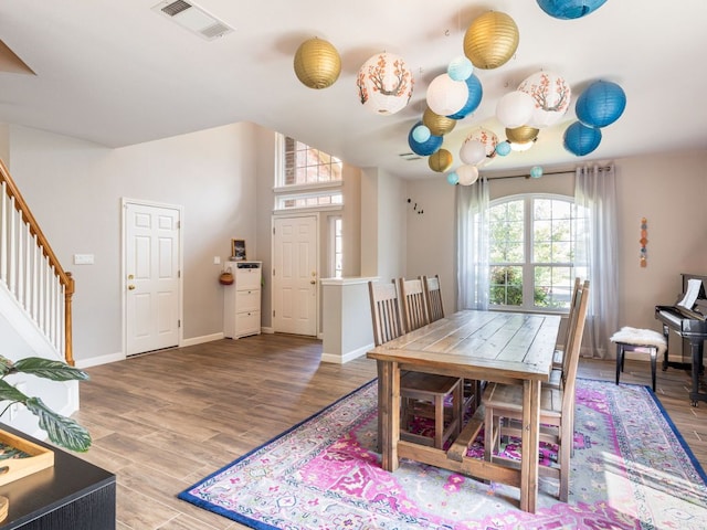 12705 Bransford Cv, Austin, TX 78753 - dining space featuring stairs, wood finished floors, and baseboards