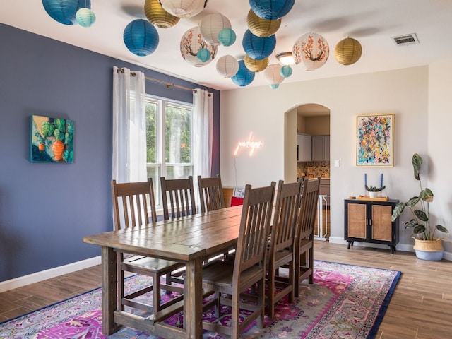 12705 Bransford Cv, Austin, TX 78753 - dining space featuring arched walkways, wood finished floors, and baseboards