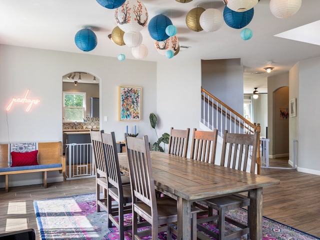 12705 Bransford Cv, Austin, TX 78753 - dining area featuring wood finished floors, ceiling fan, arched walkways, and baseboards
