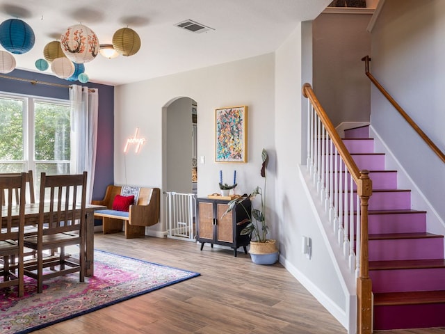 12705 Bransford Cv, Austin, TX 78753 - dining room with arched walkways, wood finished floors, baseboards, and stairs