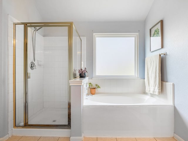12705 Bransford Cv, Austin, TX 78753 - bathroom with a stall shower, a garden tub, and tile patterned floors