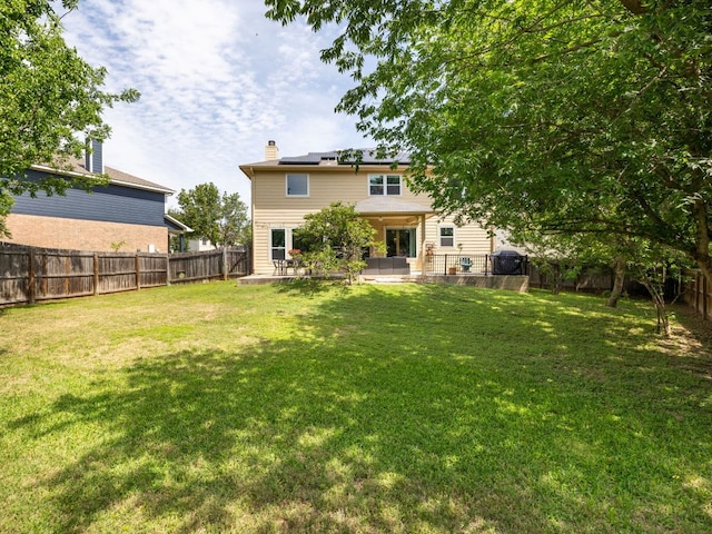 12705 Bransford Cv, Austin, TX 78753 - rear view of house featuring solar panels, a patio area, and a chimney