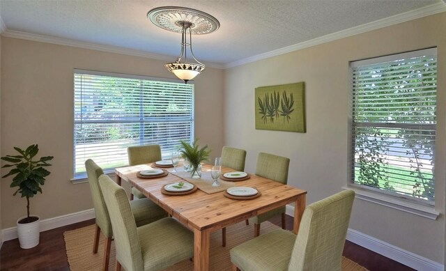 dining space featuring dark wood-style flooring, baseboards, and ornamental molding