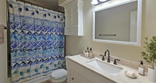 bathroom featuring vanity, toilet, and a shower with curtain