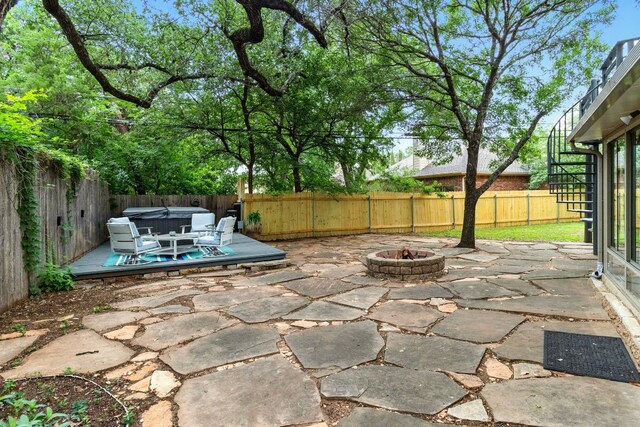 12707 Palfrey Dr, Austin, TX 78727 - fenced backyard with a hot tub, a patio, and an outdoor fire pit