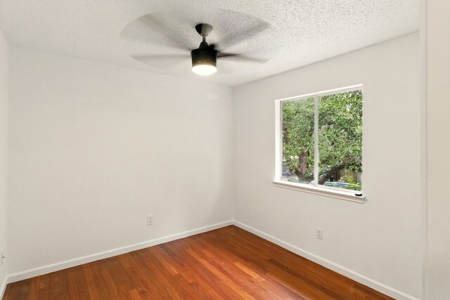 12707 Palfrey Dr, Austin, TX 78727 - unfurnished room featuring wood finished floors, ceiling fan, baseboards, and a textured ceiling