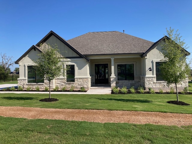 467 Yellow Bell Run, Dripping Springs, TX 78620 - view of front of house with stone siding, a front lawn, and a shingled roof