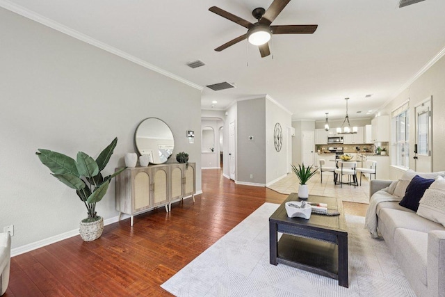10113 Cassandra Dr, Austin, TX 78717 - living area featuring a ceiling fan, crown molding, a chandelier, light wood-style flooring, and baseboards