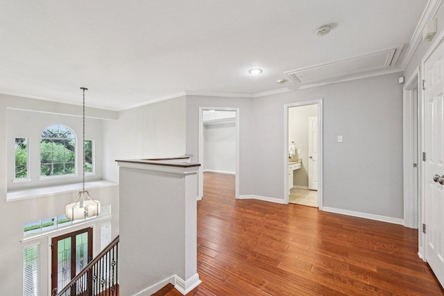 10113 Cassandra Dr, Austin, TX 78717 - corridor with attic access, an upstairs landing, ornamental molding, baseboards, and wood finished floors