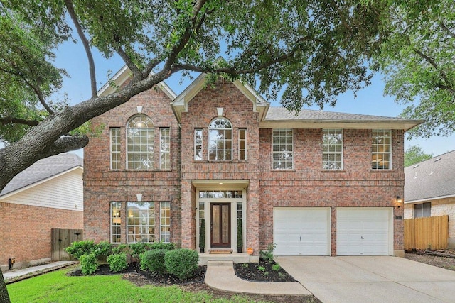 10113 Cassandra Dr, Austin, TX 78717 - view of front of home with concrete driveway, brick siding, and an attached garage