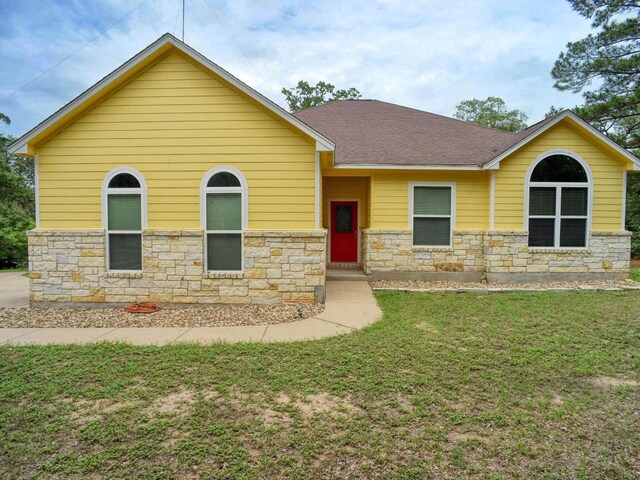247 Campfire Way, Smithville, TX 78957 - view of front of property with stone siding, a front yard, and a shingled roof