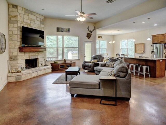 247 Campfire Way, Smithville, TX 78957 - living room featuring concrete floors, ceiling fan, recessed lighting, a stone fireplace, and baseboards