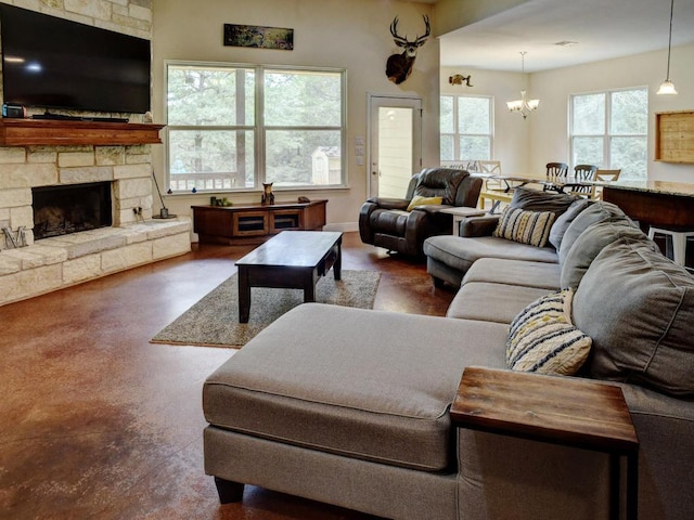 247 Campfire Way, Smithville, TX 78957 - living area featuring a chandelier, a stone fireplace, and finished concrete floors