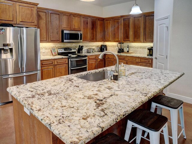247 Campfire Way, Smithville, TX 78957 - kitchen with appliances with stainless steel finishes, a sink, decorative backsplash, and light stone counters