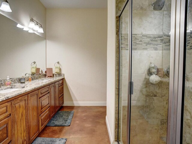 247 Campfire Way, Smithville, TX 78957 - full bath featuring double vanity, finished concrete flooring, a stall shower, and baseboards