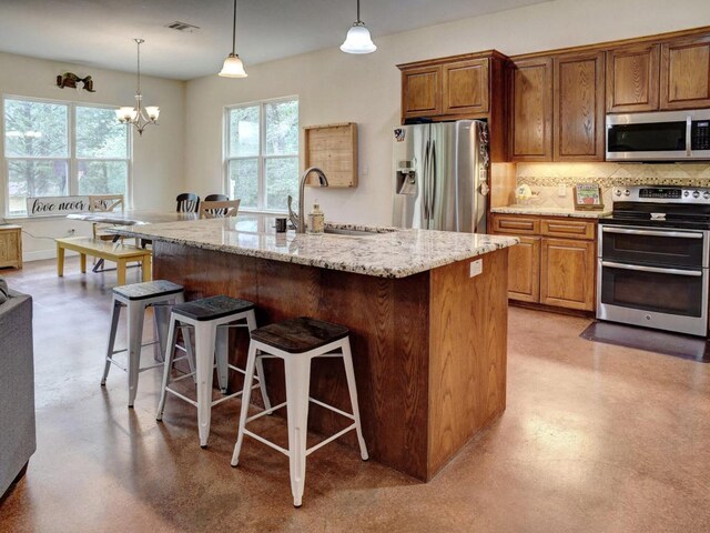 247 Campfire Way, Smithville, TX 78957 - kitchen featuring stainless steel appliances, healthy amount of natural light, a sink, and a breakfast bar