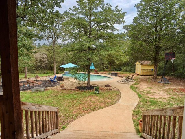 247 Campfire Way, Smithville, TX 78957 - view of community with a patio area, a pool, and a yard