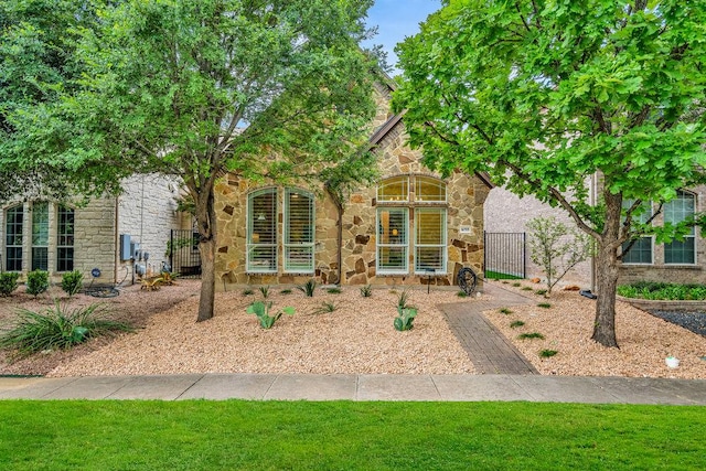 1055 Sunflower Trl, Austin, TX 78745 - view of front of home with stone siding and a gate
