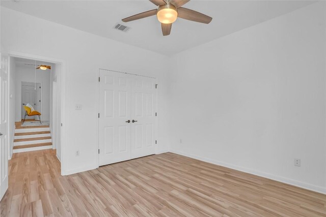 1055 Sunflower Trl, Austin, TX 78745 - unfurnished bedroom featuring light wood-style floors, a closet, and a ceiling fan