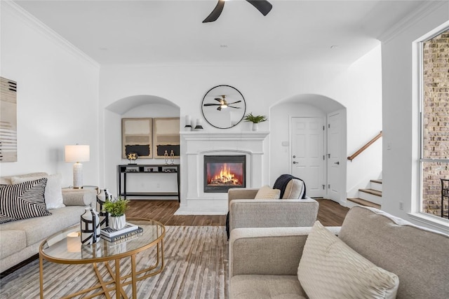 1055 Sunflower Trl, Austin, TX 78745 - living area with ceiling fan, wood finished floors, stairs, crown molding, and a glass covered fireplace