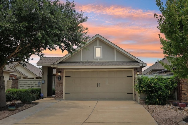 238 Rock Bluff Ln, San Marcos, TX 78666 - view of front of property featuring concrete driveway, brick siding, a garage, and roof with shingles