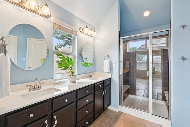 238 Rock Bluff Ln, San Marcos, TX 78666 - full bathroom with double vanity, a shower stall, lofted ceiling, and tile patterned floors