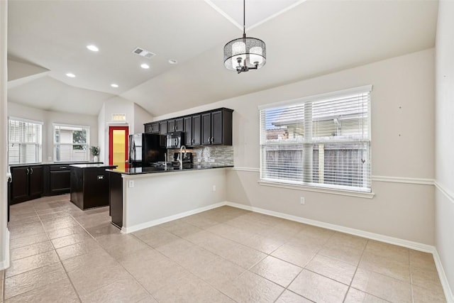 238 Rock Bluff Ln, San Marcos, TX 78666 - kitchen with black appliances, light tile patterned floors, decorative backsplash, vaulted ceiling, and a chandelier