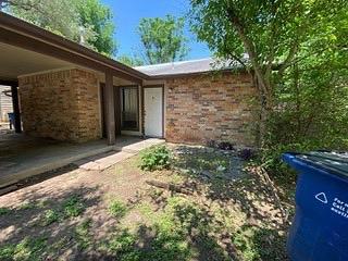 1402 Waterloo Trl, Austin, TX 78704 - doorway to property featuring brick siding
