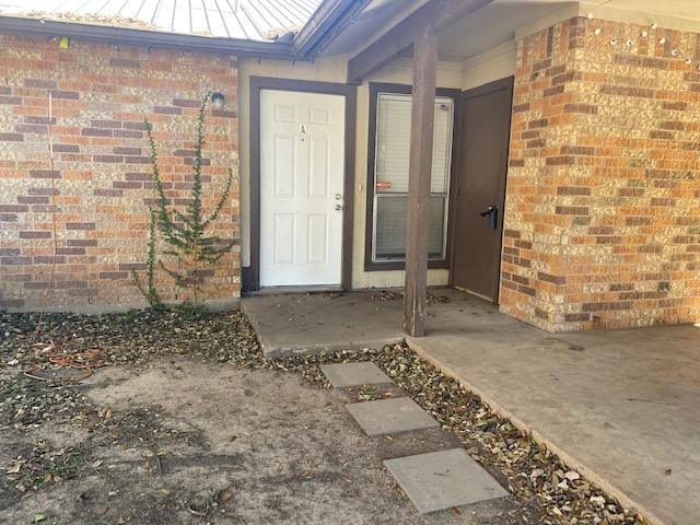 1402 Waterloo Trl, Austin, TX 78704 - property entrance with brick siding, a standing seam roof, and metal roof