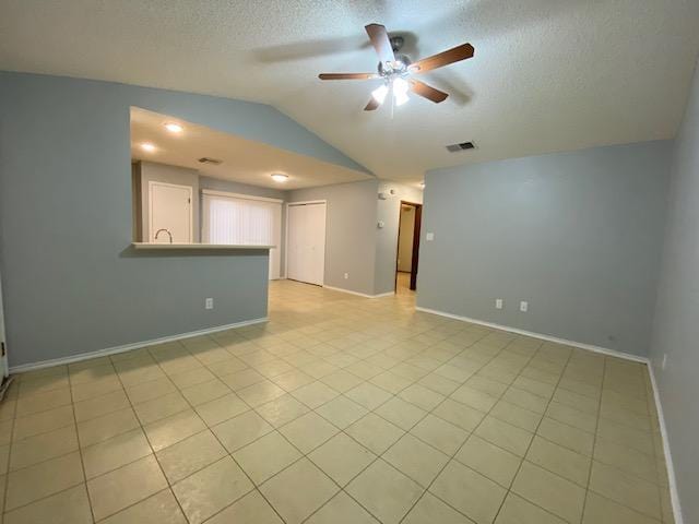 1402 Waterloo Trl, Austin, TX 78704 - empty room featuring lofted ceiling, ceiling fan, a textured ceiling, baseboards, and light tile patterned floors