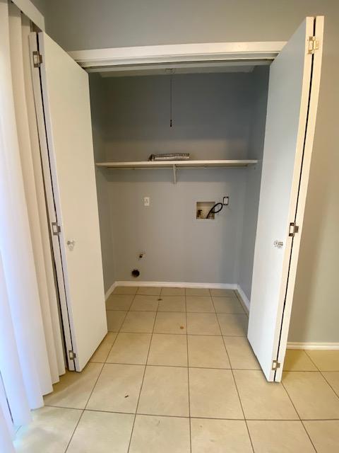 1402 Waterloo Trl, Austin, TX 78704 - washroom featuring washer hookup, light tile patterned flooring, and baseboards