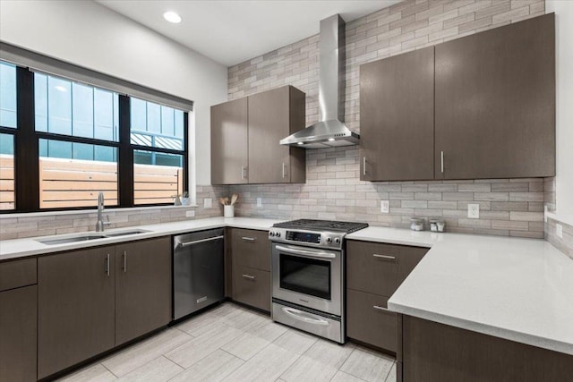 1706 Canterbury St, Austin, TX 78702 - kitchen with stainless steel appliances, wall chimney range hood, a sink, tasteful backsplash, and light countertops