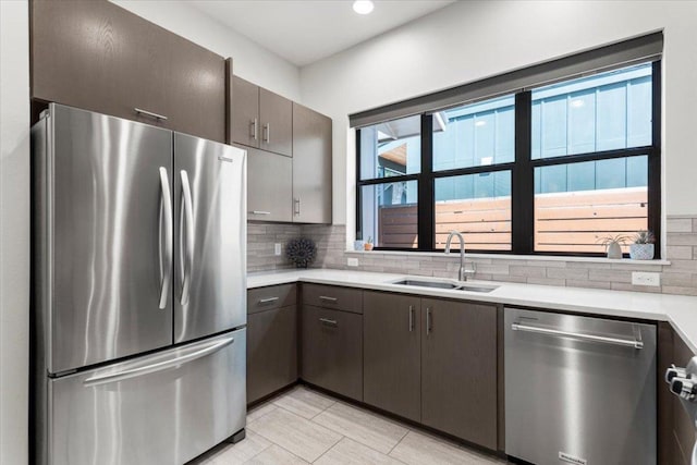 1706 Canterbury St, Austin, TX 78702 - kitchen featuring appliances with stainless steel finishes, a sink, light countertops, tasteful backsplash, and recessed lighting