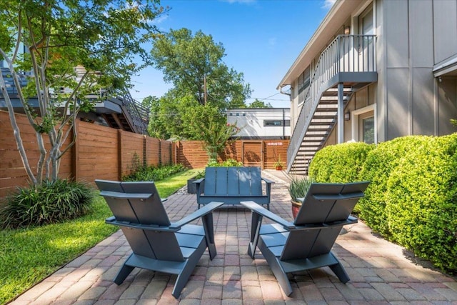 1706 Canterbury St, Austin, TX 78702 - fenced backyard with stairs, a patio area, and outdoor lounge area