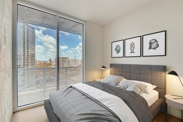 301 W Ave Unit 2003, Austin, TX 78701 - bedroom featuring floor to ceiling windows, access to outside, wood finished floors, and a view of city