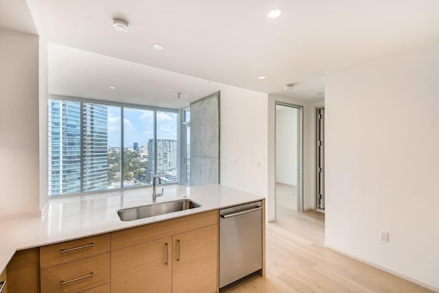 301 W Ave Unit 2003, Austin, TX 78701 - kitchen featuring stainless steel dishwasher, a sink, light wood-type flooring, light countertops, and recessed lighting