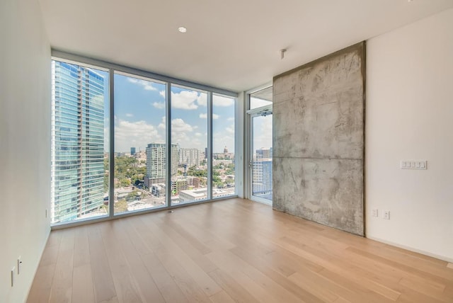 301 W Ave Unit 2003, Austin, TX 78701 - spare room with a wall of windows, wood finished floors, and a city view