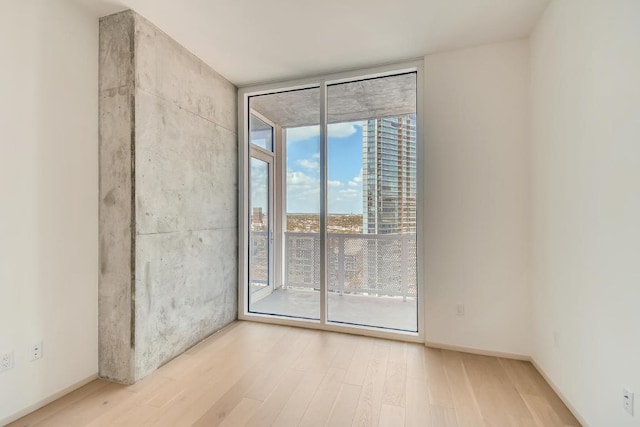 301 W Ave Unit 2003, Austin, TX 78701 - empty room with expansive windows and wood finished floors