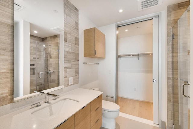 301 W Ave Unit 2003, Austin, TX 78701 - full bath featuring toilet, vanity, a shower stall, wood finished floors, and recessed lighting