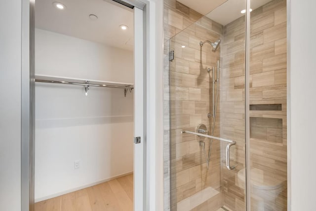 301 W Ave Unit 2003, Austin, TX 78701 - bathroom with a stall shower, recessed lighting, and wood finished floors