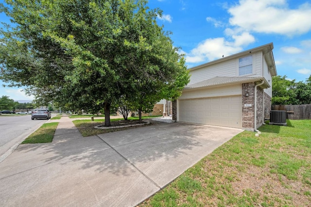 633 Sweet Leaf Ln, Pflugerville, TX 78660 - view of front of property featuring driveway, brick siding, and central AC