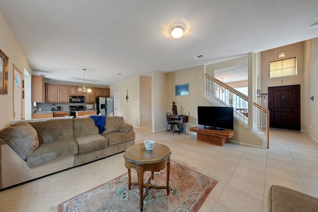 633 Sweet Leaf Ln, Pflugerville, TX 78660 - living area with stairway, a chandelier, light tile patterned floors, and baseboards