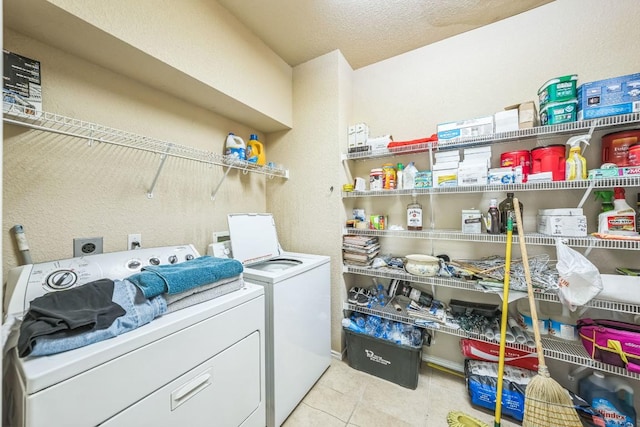 633 Sweet Leaf Ln, Pflugerville, TX 78660 - washroom with washer and clothes dryer, tile patterned floors, and a textured wall