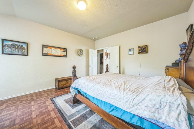 633 Sweet Leaf Ln, Pflugerville, TX 78660 - bedroom featuring a textured ceiling and baseboards