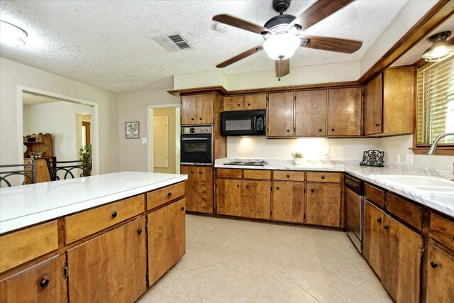 304 White Wing Way, Round Rock, TX 78664 - kitchen featuring black microwave, a sink, wall oven, stainless steel dishwasher, and brown cabinets