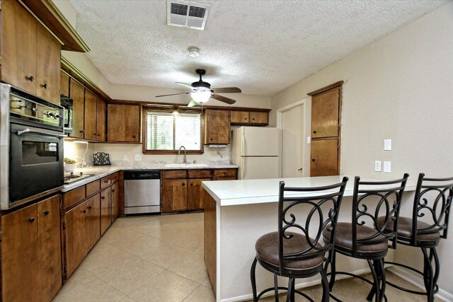 304 White Wing Way, Round Rock, TX 78664 - kitchen featuring freestanding refrigerator, stainless steel dishwasher, oven, a sink, and ceiling fan