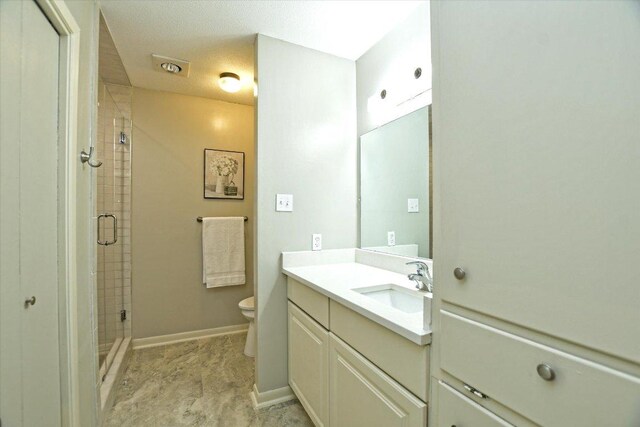 304 White Wing Way, Round Rock, TX 78664 - bathroom with vanity, a shower stall, toilet, and baseboards